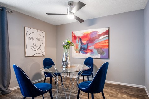 Apts in Arlington TX - dining room in Stadium 700 Apartments with table, modern chairs and artwork